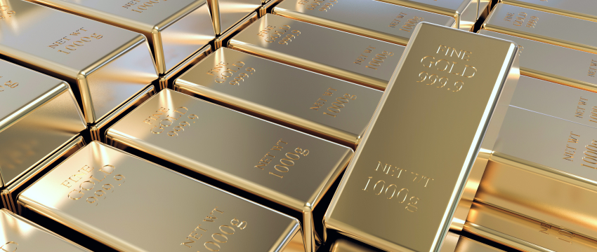 Stacks of shiny gold bars engraved with "FINE GOLD 999.9" and "NET WT 1000 g" are arranged neatly, symbolizing wealth, investment opportunities, and gold market volatility in the precious metals market.