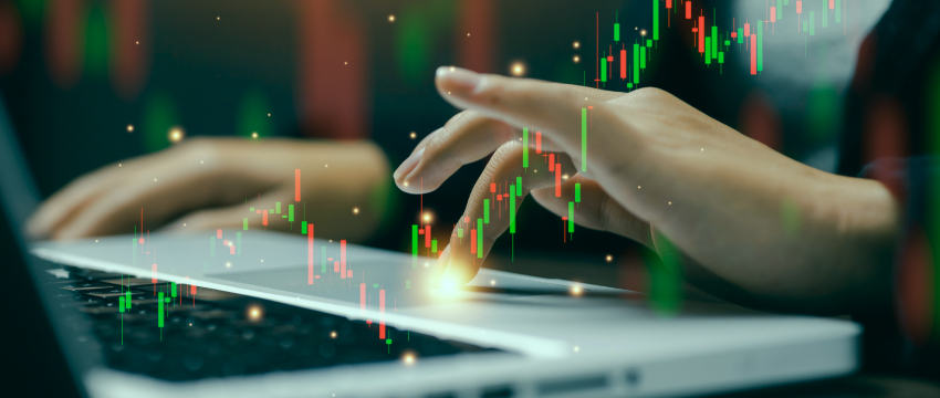 A trader's hand using a laptop touchpad with glowing red and green candlestick charts overlaid, demonstrating active trading with a Forex Performance Tracker.