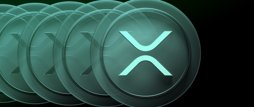 Row of teal XRP cryptocurrency coins illustrating Standard Chartered XRP 2026 forecast and market projections