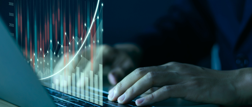 Financial professional analyzing market data and interest rate movements on a laptop